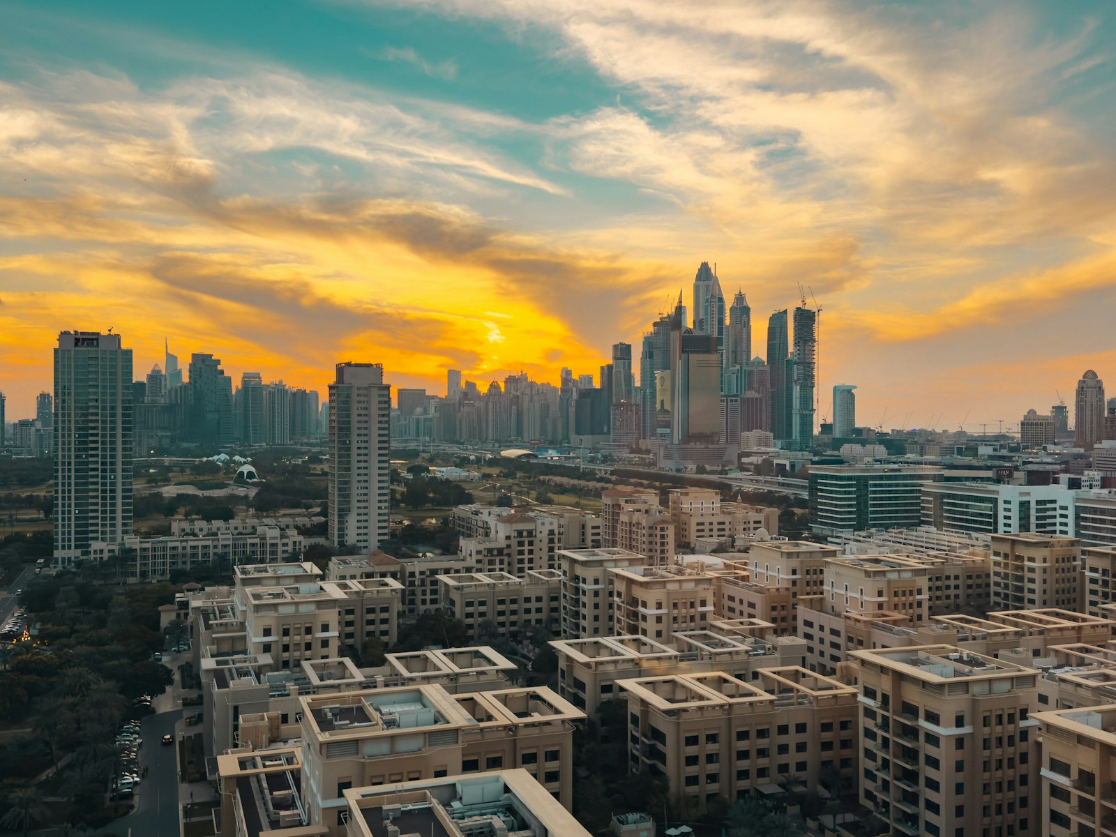 Gulf cityscape with modern buildings at sunset